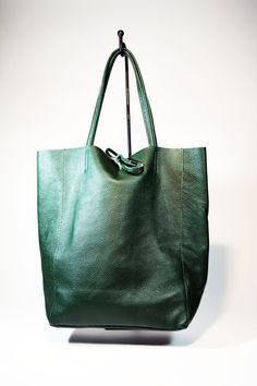 A lightweight and spacious Leather Shopping Bag-Green you can use for your office, gym and after-hours essentials while still looking stylish. Handmade from supple calfskin Italian leather, the versatile look features over-the-shoulder handles and minimal detailing. Raw edges and no lining makes this style super light and easy to fold when traveling. Inside is a zippered document pouch and a leather cell phone pouch. Details: Color: Green Two leather strap for closing the bag.Natural unlined int Minimalist Shoulder Bag With Rolled Handles For Shopping, Leather Hobo Bag With Leather Handles For Office, Casual Leather Hobo Bag For Office, Green Tote Shoulder Bag For Work, Everyday Textured Leather Shoulder Backpack, Casual Workwear Bags With Leather Lining, Office Satchel Shoulder Bag With Rolled Handles, Minimalist Shoulder Bag With Leather Handles For Office, Green Leather Shoulder Bag For Work