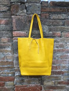 Large tote leather bag in BRIGHT  YELLOW. Large shopper bag  natural GENUINE leather. Large enough for books or a laptop, tablet, cosmetics bag etc. Leather shopper. The inside of this carry all bag  bag is not lined (although properly finished!) . We added a small leather pouch on the inner part of the bag .  The bag can be closed by 2 leather straps attached to each side. Excellent quality soft but strong genuine leather. Width upper part: 41cm - 16 inch Height: 38 cm - 15 inch (CAMEL COLOR AS Yellow Soft Leather Shoulder Bag For Everyday, Mustard Rectangular Shoulder Bag For Daily Use, Yellow Leather Bucket Bag For Everyday, Yellow Satchel Bucket Bag For Errands, Yellow Leather Shoulder Bag For Everyday Use, Yellow Shoulder Bucket Bag For Everyday Use, Mustard Shoulder Bag For Everyday Use, Yellow Bucket Bag Tote For Everyday, Yellow Soft Leather Bag For Errands