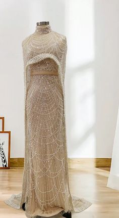 Made to order dresses will ship in 2-3 weeks as they are custom created. Unleash your inner goddess in our Luxurious Beaded Cape Dress! Featuring a champagne beaded bodice and a removable cape, this dress exudes opulence and elegance. Cinch your waist with the included satin lined belt for a flattering silhouette. Perfect for any special occasion, this dress drips with luxury. SIZE & FIT Model wears: UK 8/ EU 36/ US 4 Model's height: 171cm/5'7.5” LOOK AFTER ME Dry clean only Made to order dresse Summer Court, Beaded Cape, Laundry List, Cape Gown, Fashionable Saree Blouse Designs, Inner Goddess, Beaded Bodice, Cape Dress, Dress 16