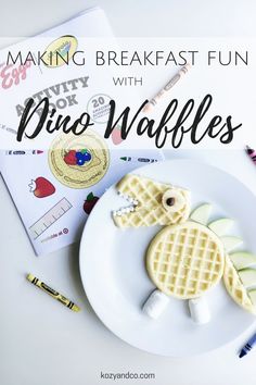 a white plate topped with waffles next to a notebook and marker pen on top of it