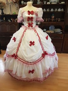 This Original dress is inspired by historical fashion around 1860. It is 100% handmade original. It is made from white polyester. It is decorated with dark red bow, lace, fliters and pink stones. The dress size is 36 - 40 ( Euro sizes )  S - L . Corset is boned and laced up at rear, therefore there is no need for under garment. At the back, the dress is laced. Skirt is buttoned up and adjustable  to suit your size. Dress is very light and extremely comfortable to wear.  Not included undergarment Pink Victorian Ball Gown Costume Dress, Pink Victorian Ball Gown Costume, Pink Victorian Dress Costume, Regency Style Victorian Dress With Ruffles For Costume, Marie Antoinette Style Victorian Costume Dress With Ruffles, White Regency Dress For Costume Party, White Vintage Victorian Dress For Costume Party, White Victorian Dress With Ruffles For Fancy Dress, White Victorian Dress For Fancy Dress