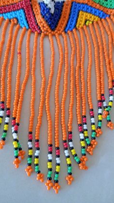 Zulu Beaded Choker necklace, African Choker necklace, Beaded Necklace for women, Tassel necklace, Fringe Necklace, Christmas gift This fringe necklace is elegantly crafted using fine Masai beads. It is attractive to wear and very light in weight. It has an adjustable clasp to fit all neck sizes. Main color - Orange. *Available in different colors kindly select the color option above. Wholesale available at a fair price,please contact me. For any clarification,please send me a convo or an e-mail. Orange Beaded Necklace With Dangling Round Beads, Festival Beaded Necklaces With Tassels And Round Beads, Orange Dangling Beads For Festivals, Orange Dangling Beads For Festival, Masai Beads, African Choker, Cowrie Shell Necklace, Cowry Shell, Seashell Necklace