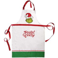 an apron with the words feelin'grinchy on it and a santa hat