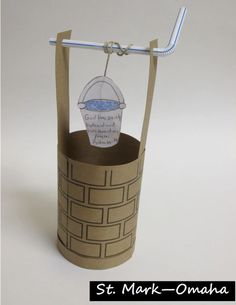 an origami model of a bucket with a toothbrush in it