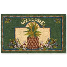 a welcome mat with a pineapple and flowers on the front, in green colors