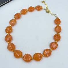 "Experience the warmth of the sun with Orange Single Strand Necklace! This vibrant piece features stunning orange beads in a single strand, adding a burst of energy and color to your style. The dainty design makes it a versatile accessory that can elevate both casual and dressy looks. Whether you're embracing the spirit of summer or brightening up your winter ensemble, this necklace is a symbol of joy and positivity. Embrace the allure of orange and let your style shine with this exquisite piece Orange Statement Necklace, Salmon Orange, Autumn Necklace, Orange Necklace, Christmas Necklace, Necklace Chunky, Handcrafted Necklace, Halloween Jewelry, Chunky Necklace