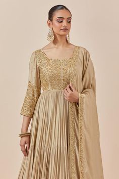 Beige chanderi silk full length anarkali with zardozi and sequin floral embroidery. Comes with embroidered border dupatta.
Components: 2
Pattern: Embroidered
Type Of Work: Floral Pattern
Neckline: Round
Sleeve Type: Straight Three Quarter
Fabric: Chanderi Silk
Color: Beige
Other Details: 
Attached lining
Back scoop neck
Tiered anarkali
Approx. product weight (in kgs): 2.5
Occasion: Wedding,Sangeet - Aza Fashions Gold Anarkali Set, Wedding Slub Silk Lehenga With Dabka Work, Semi-stitched Art Silk Anarkali Set For Eid, Gold Slub Silk Kurta For Wedding, Dola Silk Anarkali Sharara For Eid, Navratri Semi-stitched Anarkali Set In Dola Silk, Designer Anarkali Art Silk Salwar Kameez, Anarkali Set With Sheer Dupatta In Chinon, Gold Slub Silk Anarkali Set For Diwali