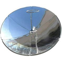 a round metal object with a circular mirror on it's side and the reflection of another object in the center