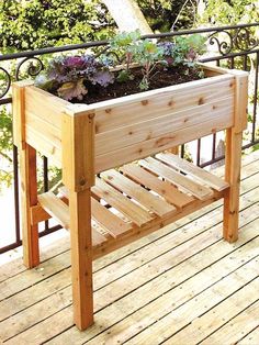 a wooden planter sitting on top of a wooden deck