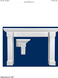 an image of a white fireplace mantel with columns and brackets on the top, in front of a blue background