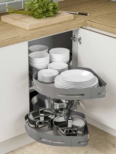 an open cabinet with plates and bowls in it