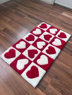 a red and white rug with hearts on it