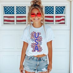 Introducing our U.S.A. t-shirt! This playful floral graphic is the perfect way to show off your patriotic side. Lightweight and breathable, this shirt will keep you comfy and stylish all day long. (USA! USA!) T-Shirt:    Comfort: Indulge in the luxurious softness and durability of 100% ring-spun cotton, providing a comfortable feel against the skin. Ideal for anyone looking for a premium unisex shirt. Pre-shrunk Patriotic Crew Neck T-shirt For Spring, White T-shirt With American Flag Print For Spring, Spring American Flag Short Sleeve T-shirt, Spring Crew Neck T-shirt With American Flag Print, Patriotic American Flag Print T-shirt For Spring, Spring T-shirt With Flag Print, American Flag Short Sleeve Top For Spring, Spring Graphic Tee With Flag Print, Spring Patriotic T-shirt With American Flag Print