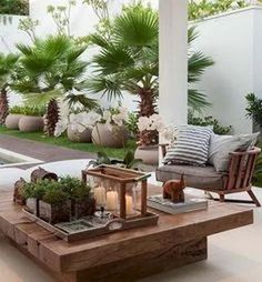 an outdoor living room with plants and candles