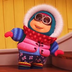 an animated character wearing winter clothing and goggles, standing in front of some stairs