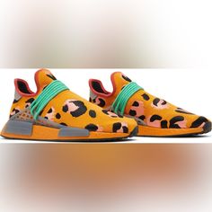 Created In Partnership With The Multi-Hyphenate Creative, The Pharrell X Adidas Nmd Human Race ‘Animal Print’ Dresses The Lifestyle Silhouette In Vibrant Hues Found In Nature. The Minimalist Upper Is Crafted From Orange Primeknit With Embroidered Leopard Spots In Black And Pink. Bright Green Rope Laces Feed Through A Midfoot Tpu Cage, Bringing Added Support To The Sock-Like Build. Responsive Cushioning Comes Courtesy Of An Orange Boost Midsole With Grey Nmd Plugs. Orange Athleisure Running Shoes With Boost Midsole, Orange Athleisure Sneakers For Running, Orange Athleisure Running Shoes, Orange Athleisure Running Shoes For Sports, Orange Athleisure Sneakers, Breathable Orange Running Shoes For Streetwear, Adidas Multicolor Running Shoes For Streetwear, Orange Breathable Sneakers For Training, Orange Breathable Training Sneakers