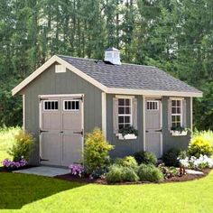 a small shed in the middle of some grass