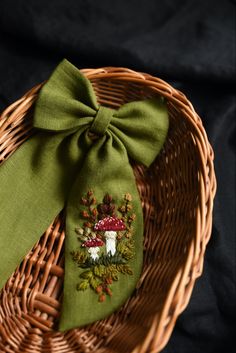 a green bow tie sitting on top of a wicker basket next to a black background