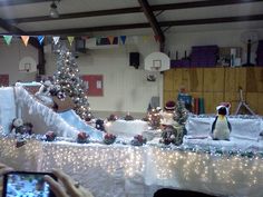 there is a christmas display with penguins and snowmen on the table in front of it