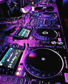 there are many dj equipment on the table