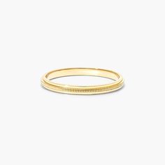 a yellow gold wedding ring on a white background