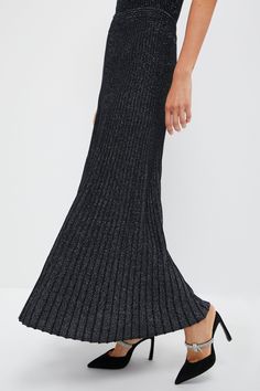 We are living for the Black Metallic Jesse Skirt. Made in an ankle-skimming length that gives it an elevated elegance, this shimmering silhouette is ultra-flattering thanks to a high rise and ribbed knit texture with plenty of stretch. It's semi-sheer for a sultry feel — so it's suited for date nights and sparkling soirees alike! Just pair this maxi with a crisp white blouse and ballet flats, with a soft sweater and heeled booties, or with a silky blouse and pumps for a showstopping look. High r Crisp White Blouse, Knit Texture, Silky Blouse, Date Nights, Soft Sweater, Sheer Material, Kids Sale, Softest Sweater, Black Metallic