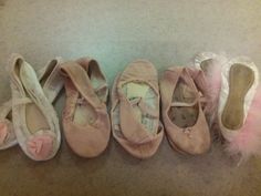 several pairs of ballet shoes lined up on the floor