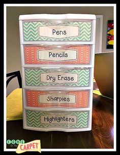 three drawers with labels on them sitting on top of a table