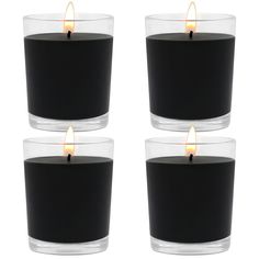 three black candles with one burning in the middle