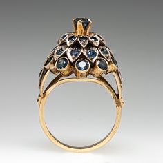 This vintage silver topped, 10K yellow gold Thai princess style ring features thirty-three (33) round cut sapphires in bead and bezel settings with milgrain edging. The ring measures 18.3mm at the top, rises 14.1mm above the finger, tapering to 2.6mm wide and 1.2mm thick at the base of the shank. The ring is currently a size 7. Antique Sapphire Ring With 17 Jewels, Victorian Sapphire Jewelry In Gold, Victorian Gold Sapphire Jewelry, Vintage Jeweled Round Rings, Antique Sapphire Ring With Intricate Design, Antique 14k Gold Sapphire Ring With Rose Cut Diamonds, Antique Yellow Gold Sapphire Ring With Rose Cut Diamonds, Collectible Vintage Sapphire Ring With Rose Cut Diamonds, Victorian Sapphire Ring In Yellow Gold