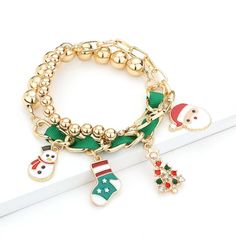 Christmas theme enamel charm bracelets;  Stretchable; Charms measure less than 1 inch; Available in gold only Buy Wholesale Jewelry, Arm Bracelets, Card Purse, Wholesale Accessories, Bridal Gloves, Head Chain, Wrist Wear, Christmas Charms, Large Hoop Earrings