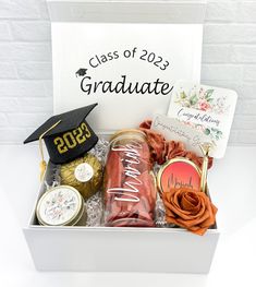 a graduate's graduation gift box with cookies and candy