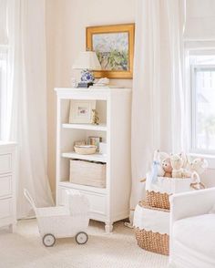 a baby's room with white furniture and decor on the walls, including a bookcase