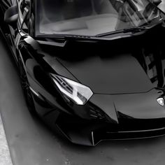 a black sports car is parked on the street