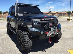 a black truck parked in a parking lot