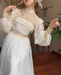 (Limited quantities) Look captivatingly royal in our ethereal Otylia dress. This enchanting Romantic Royalcore Edwardian Vintage-style garment features lace ruffles, high lace trim collar, lace neckline accent, voluminous long sleeved and accented waist with ribbon belt. The waist is stretchy. Royal Princess Dress, Fairy Woman, Cottage Dress, Princess Outfit, Dark Academia Clothing, Dress Fairy, Gatsby Dress, Fairy Dresses, Romantic Lace