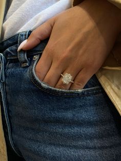 a close up of a person's hand wearing a ring