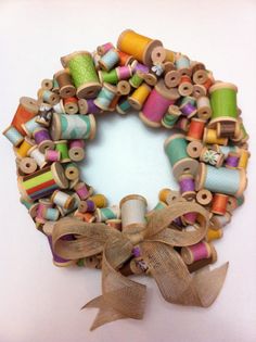 a close up of a wreath made out of different types of thread and spools