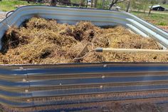 a large metal tub filled with lots of hay