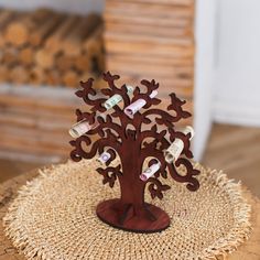 a wooden tree with wine bottles in it sitting on a straw tablecloth covered placemat