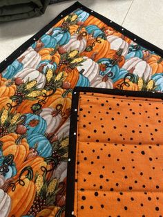 two quilted place mats with pumpkins on them