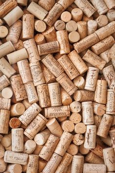 many different types of wine corks stacked on top of each other in a pile