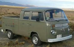 an old green truck is parked in the desert