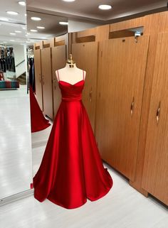 This exquisite red satin gown is elegantly showcased in a store, capturing attention with its vibrant hue and luxurious fabric. The dress exudes sophistication and allure, perfect for special occasions or formal events. Its flattering silhouette and attention to detail make it a standout choice for those seeking a glamorous and timeless look. With its captivating design and impeccable craftsmanship, this red dress is sure to make a lasting impression. Red Silk Dresses, Red Bridesmaid Dresses Long, Red Silk Prom Dress, Red Silk Gown, Flared Bridesmaid Dresses, Bridesmaid Satin Dresses, Bridesmaid Dresses Red, Moh Dress, Red Satin Prom Dress