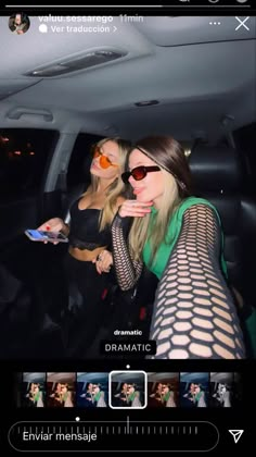 two beautiful women sitting in the back of a car