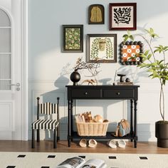 a living room with pictures on the wall and a table in front of an open door