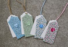 four tags are laid out on the floor to be used as ornaments or gift tags