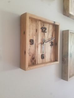 a wooden clock mounted to the side of a wall