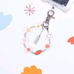 the key chain is attached to an id card holder with flowers and hearts on it