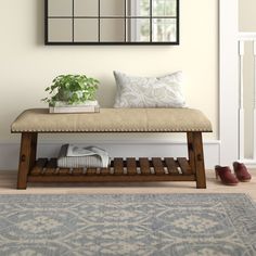 a bench with a plant on it in front of a mirror and door way to another room